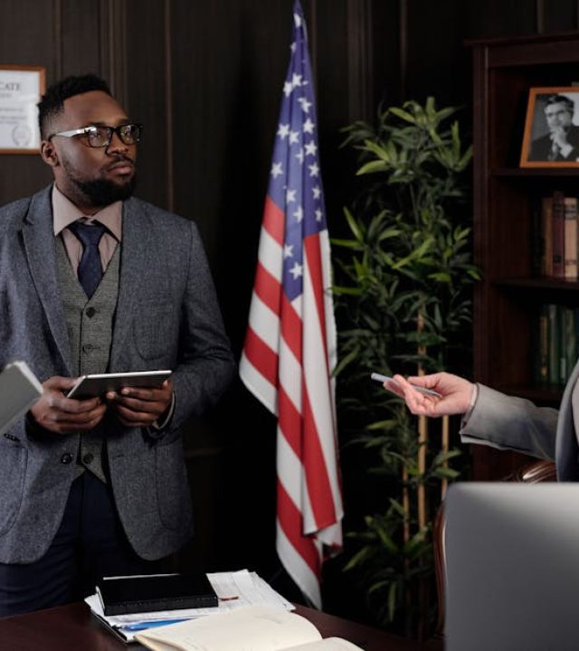 Diverse group of lawyers in a serious office meeting discussing legal matters.